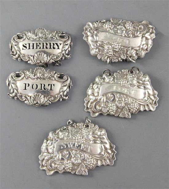 A set of George III silver bacchic motif decanter labels and a pair